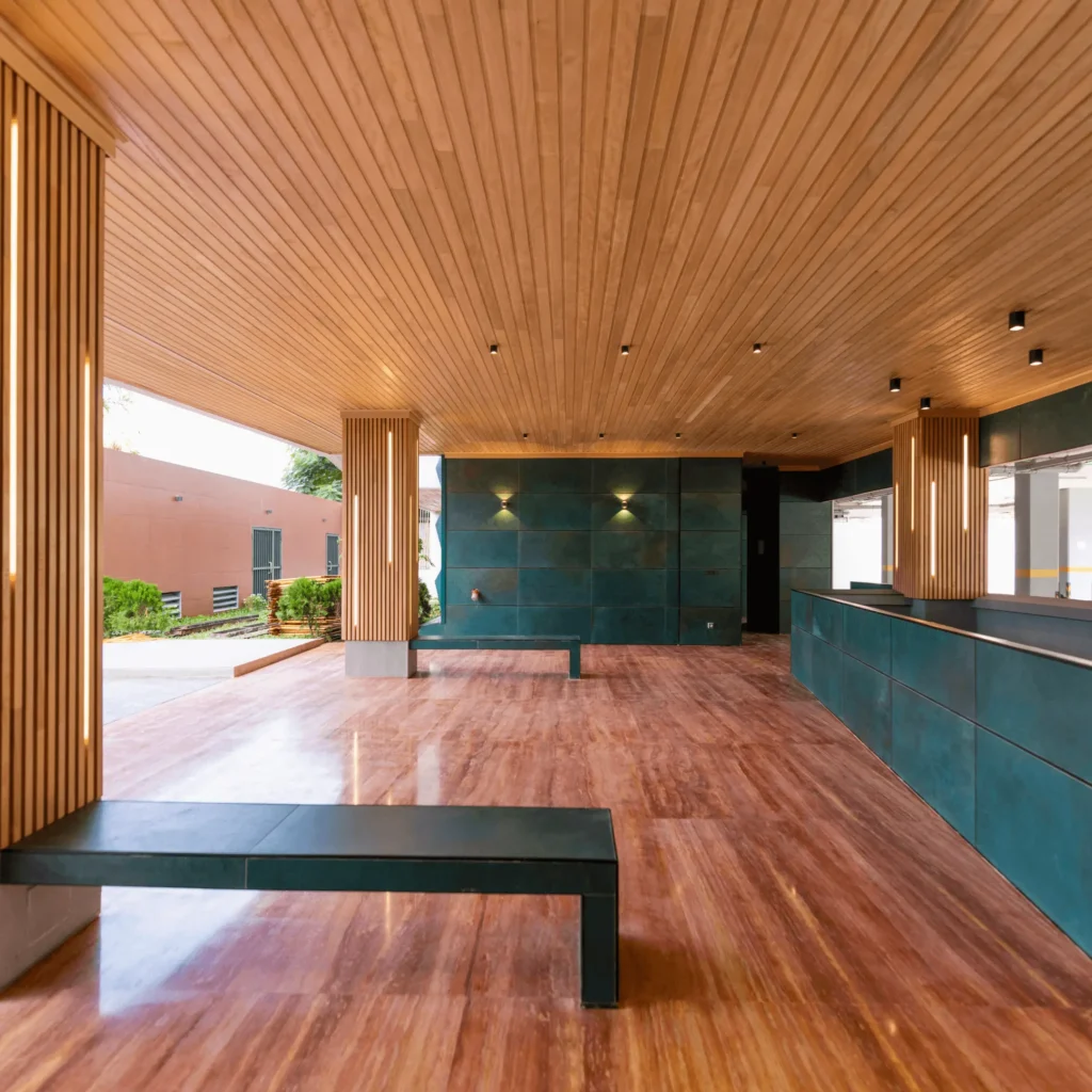 Faux plafond en lattes de bois massif avec éclairage intégré pour couloir moderne.